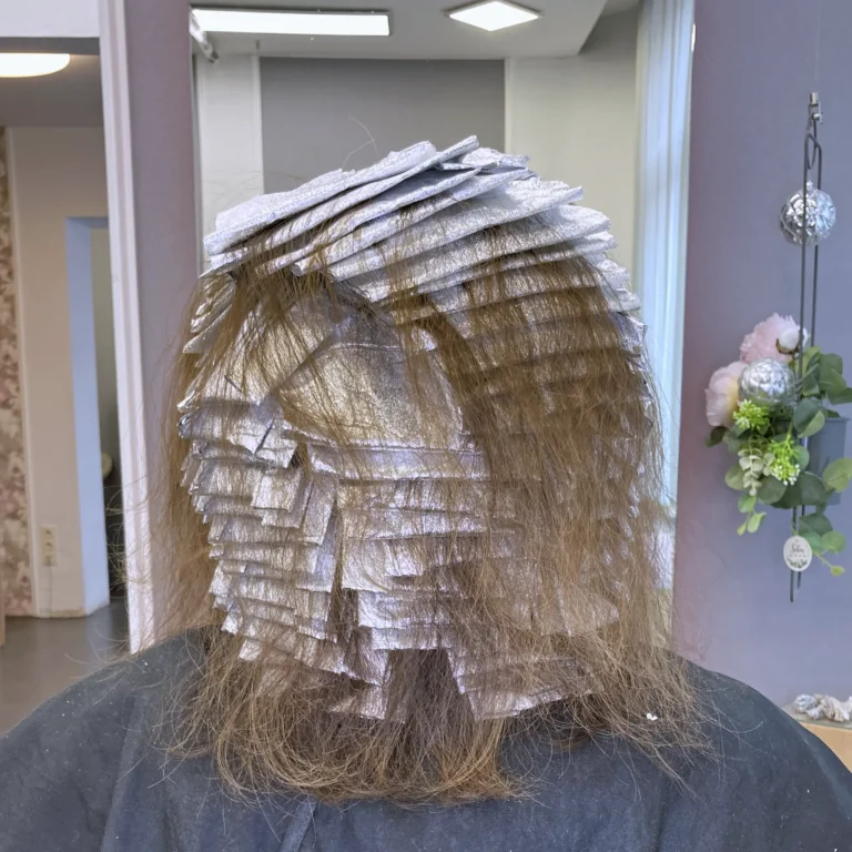 Präzise Platzierung von Blond-Strähnen in Folie für einen individuellen Blond-Look im Friseursalon Susan Matz - Coiffeur in Nürnberg. Zeigt detailreiche Folientechnik für Blondlook.